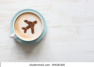 Flying airplane made of cinnamon in cappuccino. White background.
Traveling concept. Airport cafe. Copy space for text