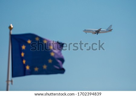 flying airplane in the sky against the background of the flag of the European Union, flying under quarantine conditions, pandemics around the world, air carriers in quarantine