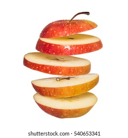 Flying Apple. Sliced Red Apple Isolated On White Background. Levity Fruit Floating In The Air