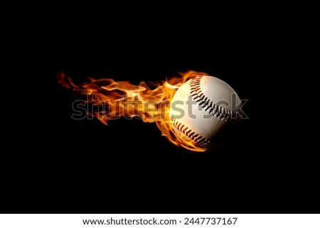 Flying baseball in flames on black background