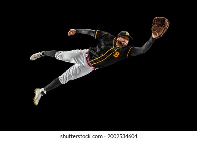 Flying. Baseball player, catcher in sports uniform and equipment practicing isolated on a black studio background. Competition, show, movement and team sport concept. Copy space for ad. - Powered by Shutterstock