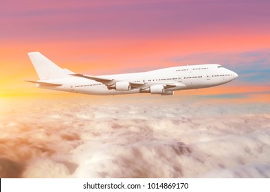 Flying Bid Double Decker Airplane Above The Clouds Horizon Sky With Bright Sunset Colors