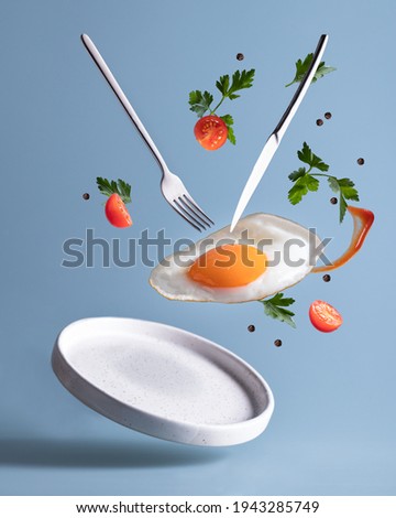 Flying breakfast with egg, knife and fork