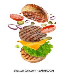Flying burger. Big tasty hamburger with flying elements.  Explosive cheeseburger - Shutterstock ID 2080507006