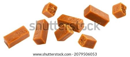 Flying caramel candies isolated on white background