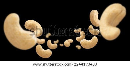 Flying cashew nuts, isolated on black background
