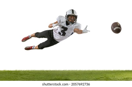 Flying, catching ball. Portrait of American football player training isolated on white studio background with green grass. Concept of sport, movement, achievements. Copy space for ad