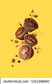 Flying chocolate cupcakes or cookies on yellow background. Mock up. Background concept.