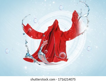 Flying Clean Clothes With Splashes Of Water On Color Background