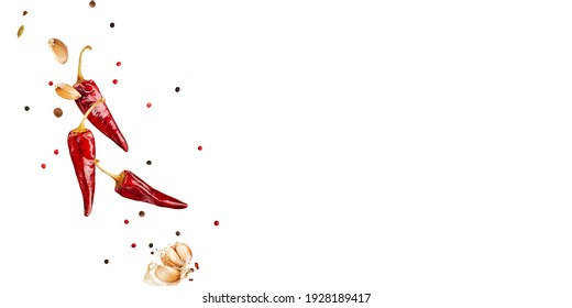 Flying  colorful spices peppers, chili, garlic  in the air isolated on white background. Food and cuisine ingredients top view, with copy space. banner.