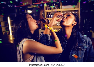 Flying colors against friends having tequila shot - Powered by Shutterstock