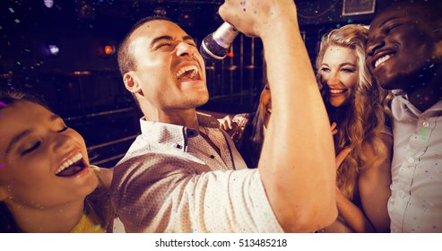 Flying colours against friends singing at karaoke - Powered by Shutterstock