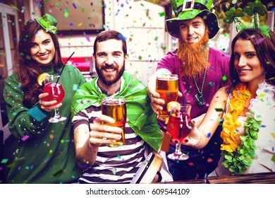 Flying colours against portrait of friends toasting and celebrating st patricks day 3d
