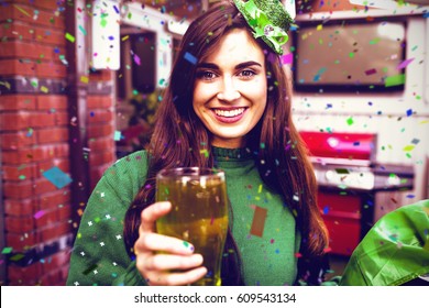 Flying colours against portrait of smiling woman holding a green pint 3d