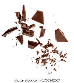 Flying Dark chocolate pieces isolated on white background.  Chocolate bar chunks, shavings and cocoa crumbs Top view. Flat lay