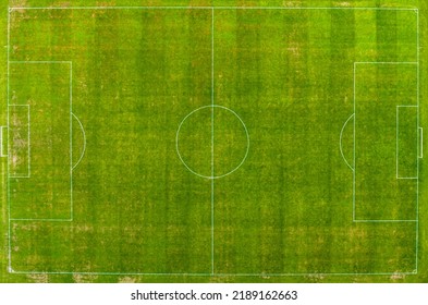 Flying A Drone Over A Modern Football Field. View Of The Manicured Lawn Of The Stadium And The Treadmill From Above. Irrigation And Lawn Care Systems Of The Sports Complex.