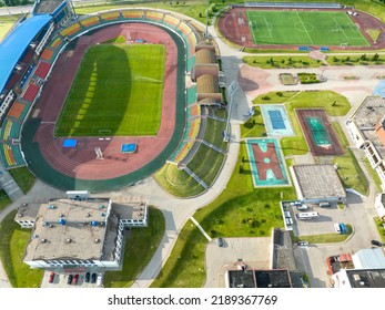 Flying A Drone Over A Modern Football Field. View Of The Manicured Lawn Of The Stadium And The Treadmill From Above. Irrigation And Lawn Care Systems Of The Sports Complex.