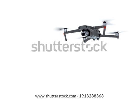 Flying drone quadcopter with a camera isolated on white background.