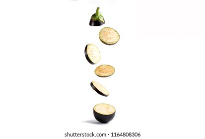 Flying eggplant slices on a white background. Isolated. Minimal fruit concept.