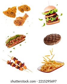 flying fast food dishes isolated on white abstract background. floating burger, steak, French fries, chicken sticks, fried chicken, hot dog. abstract fast food mock up and template design. - Shutterstock ID 2215295697