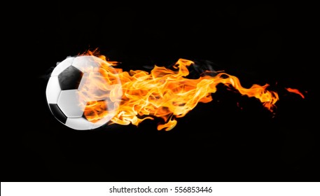 Flying football or soccer ball on fire. Isolated on black background.
