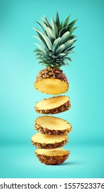 Flying fresh ripe pineapple slices on blue background