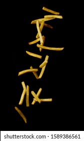 Flying fried potatoes isolated on a black background 