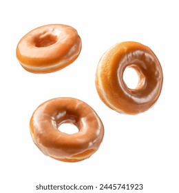 Flying glazed donuts isolated on white background. Sweet and plain and glazed doughnuts falling or flying in motion. Floating sweet donuts.