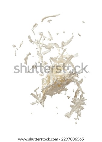 Flying grated white brine cheese on white background