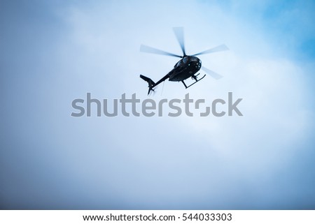 Flying helicopters in the sky.