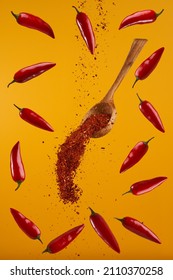 Flying Hot Chili And Pepper Flakes On Yellow Background