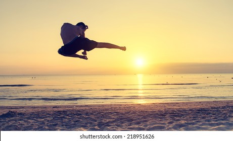 Flying Kick On The Beach At Sunrise