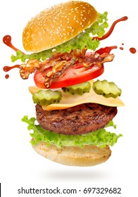 Flying Layers Of Bacon Cheeseburger On White Background