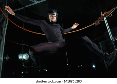 Flying Man In Black In Wind Tunnel