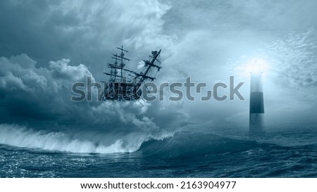 Flying old sailing ship at the stormy sea with lighthouse in the background and strong sea wave 