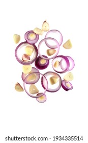 Flying Onion Rings And Sliced Garlic Cloves Isolated On A White Background.