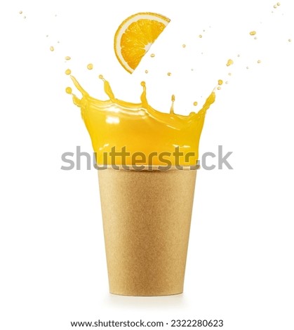 Flying orange slice falling into overflowing paper cup. Freshly-squeezed orange juice in to go packaging. Real shot.
