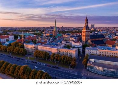 Flying over beautiful old town of Riga, Latvia at sunset with Domes cathedral and golden cock statue in the foreground. - Shutterstock ID 1779455357