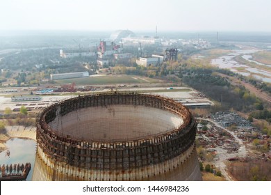 Flying Over The Cooling Tower Near The Chernobyl Nuclear Power Plant. Territory Near The Chernobyl NPP. Piles Of Metal And Equipment Contaminated By Radiation Are On Special Sites. Exclusion Zone.