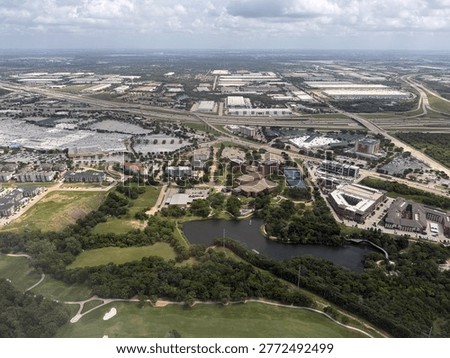 Flying over the Grapevine Mills Outlet Mall, the Texas Frontage Road, a golf course, and townhomes. Beyond that, multiple warehouses and distribution centers.