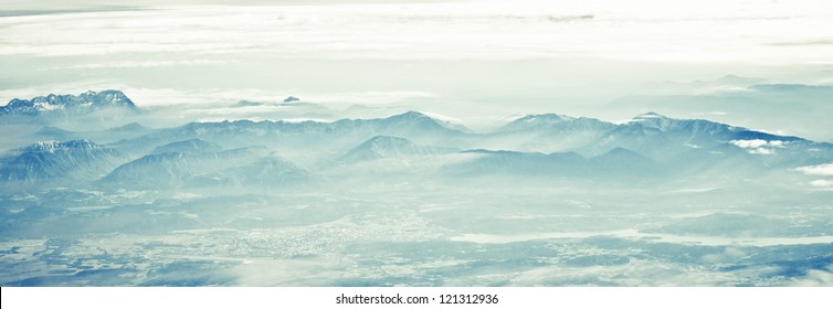 Flying over the mountains with clouds