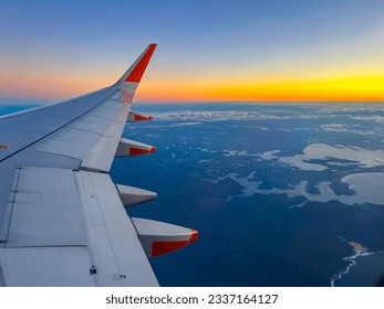 Flying over Sydney NSW airport heading to Melbourne Victoria VIC Australia early winner morning sunrise on the horizon - Powered by Shutterstock