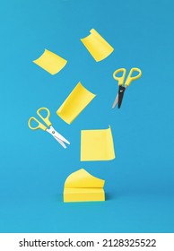 Flying paper for notes and scissors on a blue background. Minimal concept of office supplies. Office supplies.