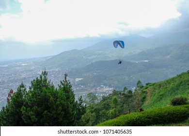 Flying Paraglider on sky by Paragliding over upcountry for agriculture area and beautiful city in countryside Asia.