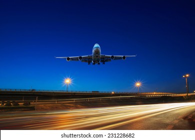 flying passenger jet plane above traffic light on express ways use as transportation background