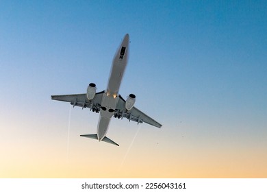Flying passenger plane in the blue sky - Shutterstock ID 2256043161