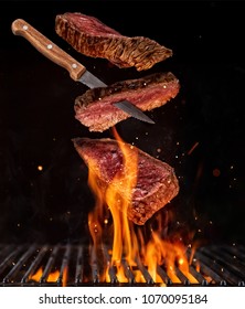 Flying pieces of beef steaks from grill grid, isolated on black background. Concept of flying food, very high resolution image - Shutterstock ID 1070095184