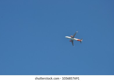 flying plane in the cloudless sky. bottom view