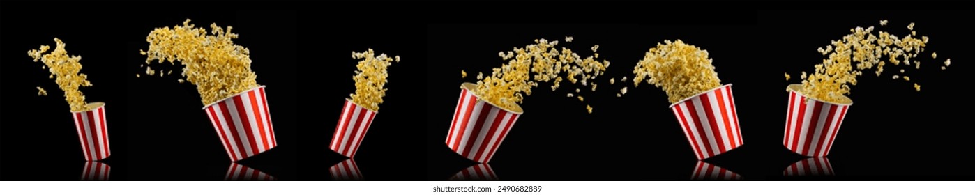 Flying popcorn from paper striped bucket isolated on black background, concept of watching TV or cinema. - Powered by Shutterstock