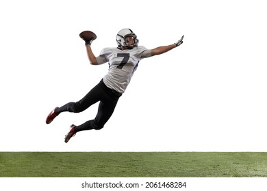 Flying. Portrait of American football player catching ball in jump isolated on white studio background with grass. Concept of sport, movement, achievements. Copy space for ad